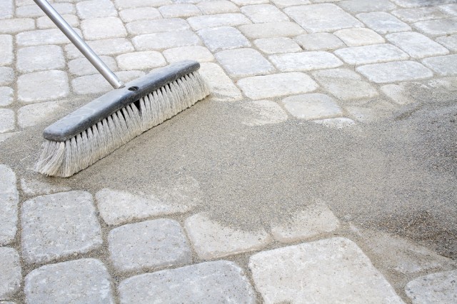 sweeping-in-polymeric-sand-on-interlocking-driveway-extension