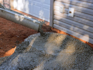 Wet cement being poured on to a driveway