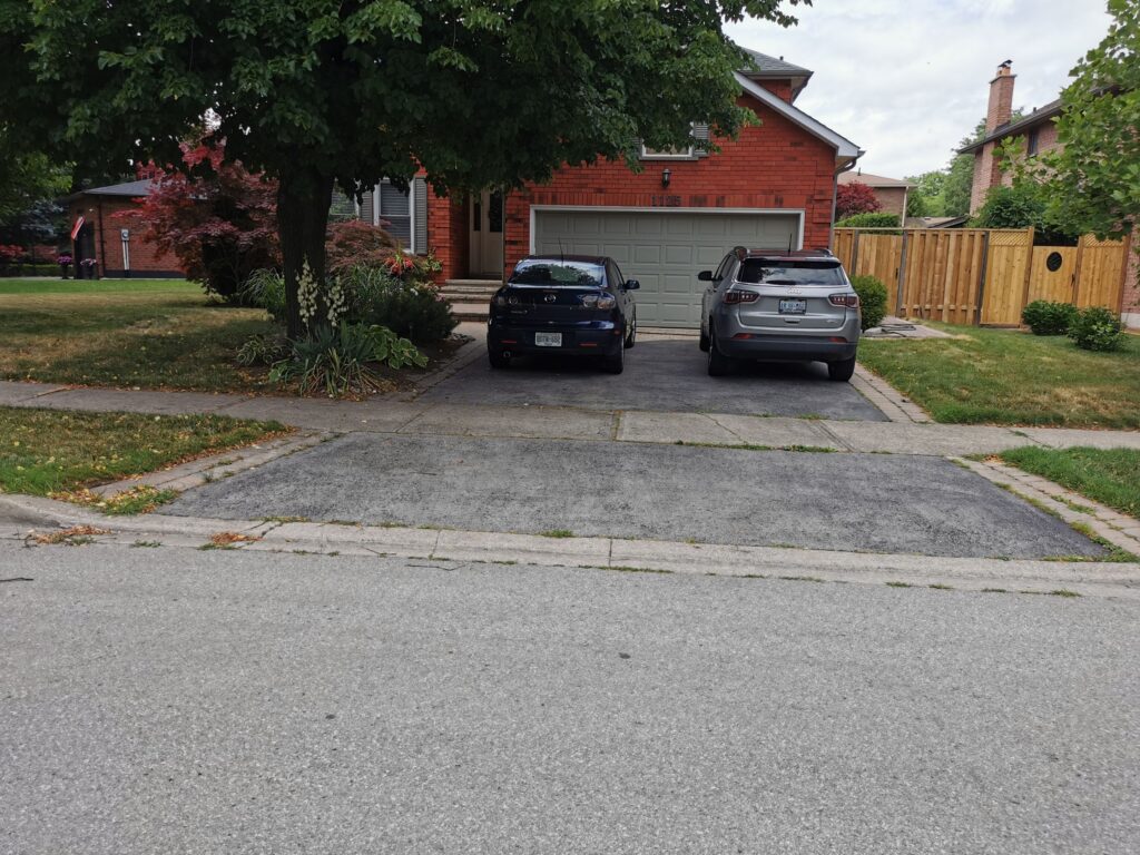 Home driveway paving with two parked cars